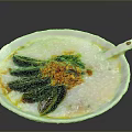 Savory Congee Topped with Century Egg Green Onions Chili Flakes in White Bowl with Spoon