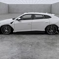 White Sporty SUV Car With Large Black Accented Wheels In Indoor Gray Floor And Walls