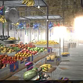Colorful Fresh Fruits at Market Stalls With Hanging Decorations and Clock