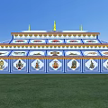 Traditional Multi tiered Religious Building With Blue White Design And Golden Spires On Green Grass