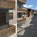 Traditional And Modern Commercial Street With Wooden Balconies And Stone Paved Road