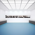 Spacious Gallery Interior With Glass Skylight White Walls Blue Flooring Hanging Artworks And Display Cabinets