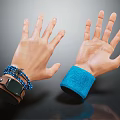 Man's Hands Featuring Watch Multiple Bracelets And Blue Cuff On Wrists