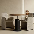 Modern Table And Chairs Set With Round Wooden Tabletop Textured Fabric Chairs And Neutral Wall