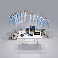 Retail Display Shelving with Hanging Light Blue Shirts Tablet Shoes Plants and Logo on Table