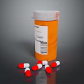 Orange Pill Bottle With White Label And Scattered Red White Capsules