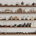 Traditional Tea Utensils Display with Teapots Teacups and Round Tea Cakes on Shelves