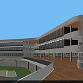Modern School Building With Green Roof And Sports Field Surrounded By Trees