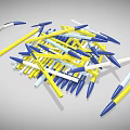 Pile of Blue Yellow and White Ballpoint Pens Scattered on Gray Background