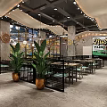 Modern Restaurant Interior With Unique Ceiling Pendant Lights Black Metal Partitions And Green Plants