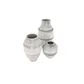Handcrafted Ceramic Jars with Textured Surface Against Gray Wall and Wooden Floor