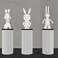 White Rabbit Sculptures With Red Polka Dots On Decorative Pedestals In Modern Room