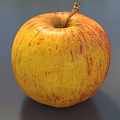 Fresh Juicy Red and Yellow Apple with Stem on Gray Background Close Up