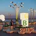 GB Sweets Outdoor Display With Neon Lights Seating And Green Plants