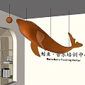 Orange Whale Hanging Pendant In Music Training Center Interior With Bookshelves And Arched Design