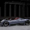 Gray Convertible Sports Car With Red Seats And Black Wheels Against Ancient Stone Columns