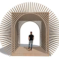 Wooden Pergola With Radial Slats Arched Entrance In Outdoor Garden Greenery People Walking