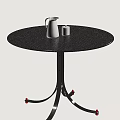 Modern Round Dining Table With Metal Legs And Red Wheels Featuring White Kettle And Cup