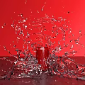 Red Garden Ornament Vase With Splashing Water On Red Background