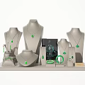 Elegant Green Emerald Jewelry Display With Pendants Bracelets And Rings On Gray Mannequin Stand