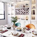 Elegant Restaurant Dining Area With Marble Table Green Orange Chairs White Cabinets And Wine Rack