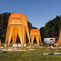 Margon Happy Island Campsite With Orange Tents Trailer And Tables On Grassland Surrounded By Trees