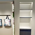 LIVE IN LIGHTHOUSE Store Interior Design With Display Cabinets Plants And Chandeliers