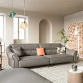 Modern Gray Leather Sectional Sofa Set With Orange And Patterned Pillows In Bright Living Room