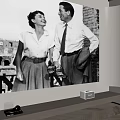 Home Theater Room With Black And White Film Projection On Wall And Projector
