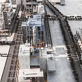 Aerial View Of Modern Industrial Factory Building With Large Structures Pipes Equipment And Roads