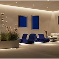 Modern Hotel Public Lounge Area With White Sofas Blue Chairs Wall Art And Green Plants