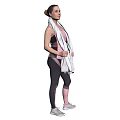 Fit woman wearing pink tank top black leggings with white towel and gray sneakers