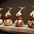 Decorative Gourd Shaped Ornament Set Featuring Colorful Patterns On Wooden Surface