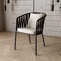 Modern Dining Chair With Black Frame Woven Backrest Light Padded Seat And Wooden Floor