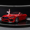 Red Convertible Sports Car With Girl In White Outfit On Black Display Platform