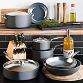 Modern Gray Cookware Set With Pots Pans Knife Block And Olive Oil On Kitchen Counter