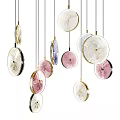 Colorful Decorative Chandeliers With Circular Design And Metallic Accents Hanging In Modern Room