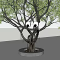 Artistic Tree Light Box Installation With Round Base And Green Foliage
