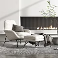 Comfortable Single Sofa With Ottoman Fireplace Background And Green Plant Decor
