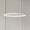 Modern White Circular Chandelier Hanging in Minimalist Interior with White Ceiling and Thin Cords