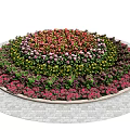Colorful Flowers and Plants Arranged in Round Bed with Concentric Circles on Stone Paved Ground