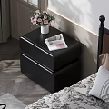 Black Leather Nightstand With White Vase Pink Flowers And Open Magazine By Bed