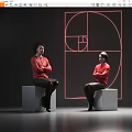 Two Women Wearing Red Blouses Sitting On Gray Cubes With Red Geometric Design