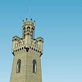 Historic Stone Brick Tower With Turrets Arched Windows And Decorative Spire Against Blue Sky