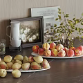 Fresh Peaches and Pears on Plates with Pitcher Glass and Green Plant on Kitchen Table