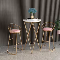 Modern Luxury Bar Stools with Golden Metal Legs and Gray Padded Seats in Contemporary Interior
