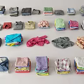 Neatly Folded Assorted Colored Clothes In Different Styles And Patterns