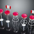 Red Bar Stools With White And Red Backs Metal Spiral Frames On Black Reflective Surface