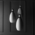 Vintage Glass Pendant Lights With Filament Bulbs Metallic Bases On Dark Vertical Panel Wall