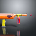 Orange And Yellow Toy Gun With Blue Button Red Parts Flying Red Projectiles From Muzzle